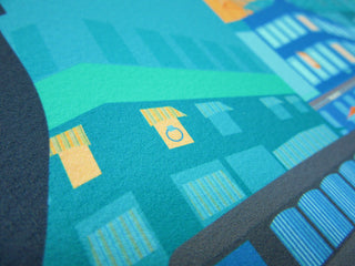 Angled view of a building in a bespoke print with a ring in a window.
