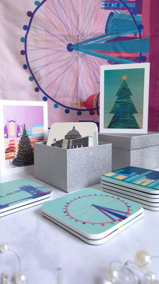 colourful gifts with pink London skyline tea towel, black and white coasters in sparkly silver gift boxes and turquoise and teal coasters lying on a table