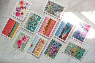 Flatlay of 11 illustrated greetings cards by South Island Art.
