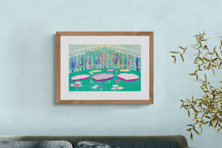 Framed print by South Island Art featuring water lilies in a glasshouse, hanging on a pale blue wall.