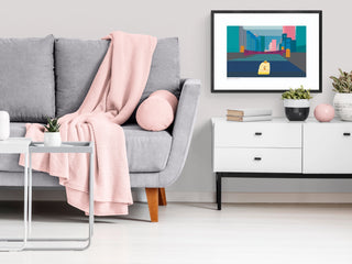 Chicago skyline art print by South Island Art in a modern living room with grey sofa, white sideboard and pink accessories.