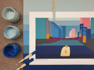 Art print of Chicago on top of a blue striped canvas. Blue paint pots sit to the left, with two blue swatch sticks on top of the print.