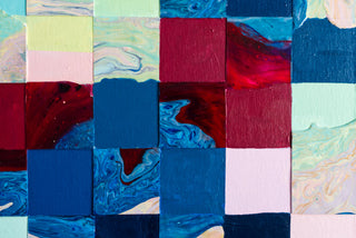 Blue and red patchwork painted squares on a detail from an original painting.
