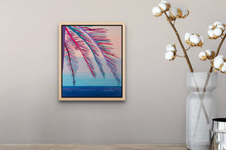 Under the Palm Trees painting in a natural wooden frame hangs on a neutral wall above a wooden table.