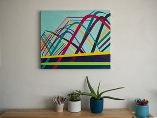 Abstract painting Dance Party by South Island Art hanging on a plain off-white wall above a desk with plants.